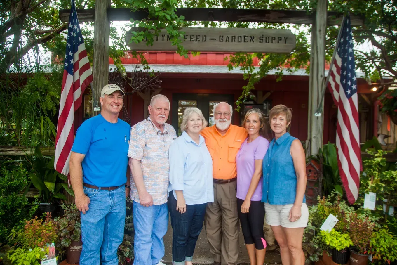A group of people are posing for a picture in front of a building.