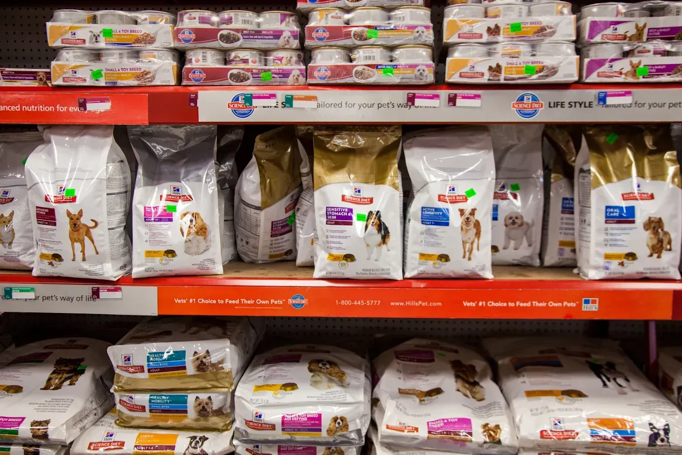 A shelf filled with bags of dog food in a store.