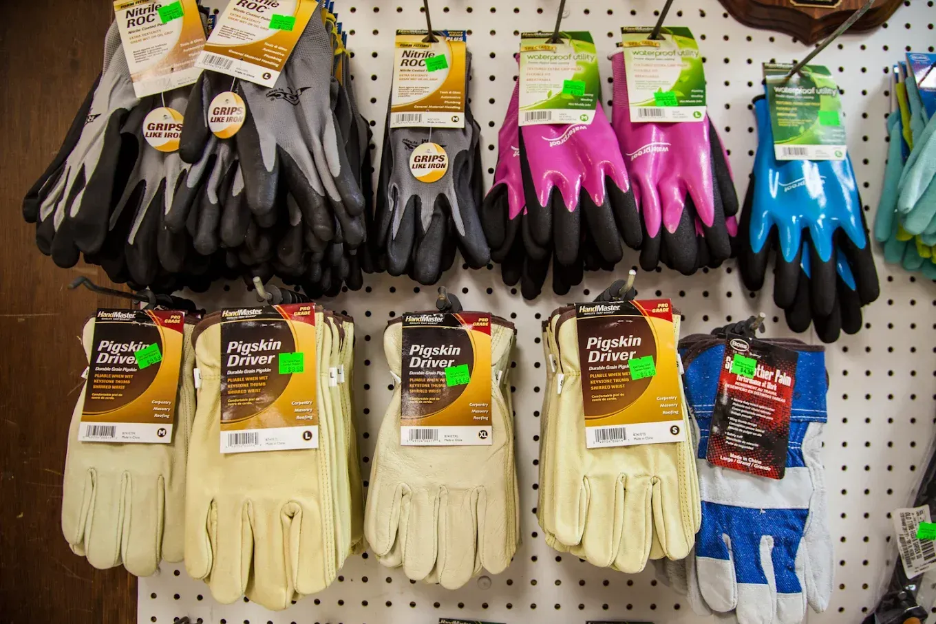 A bunch of gloves are hanging on a wall in a store