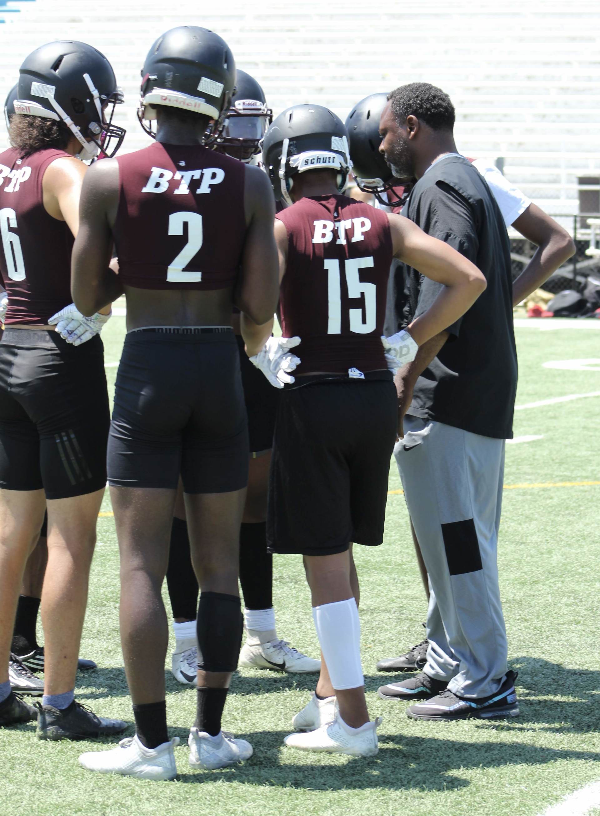 A group of football players wearing btp uniforms are standing on a field