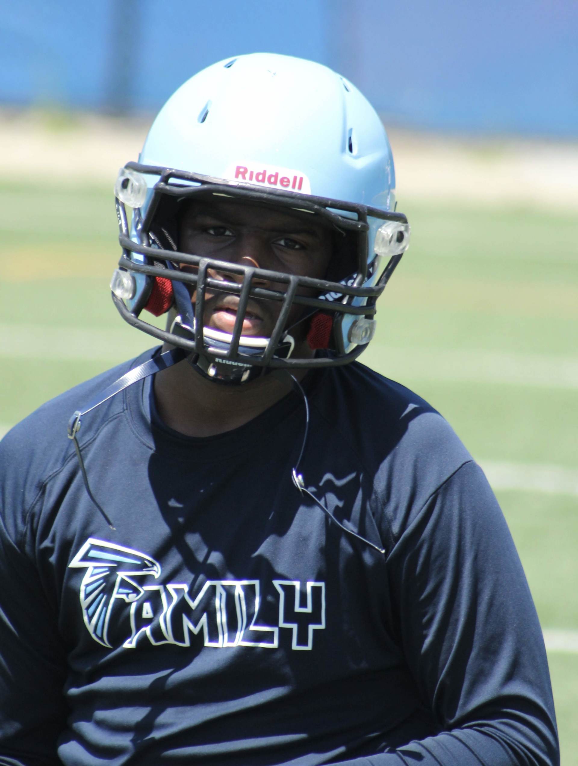 A football player wearing a helmet and a shirt that says family