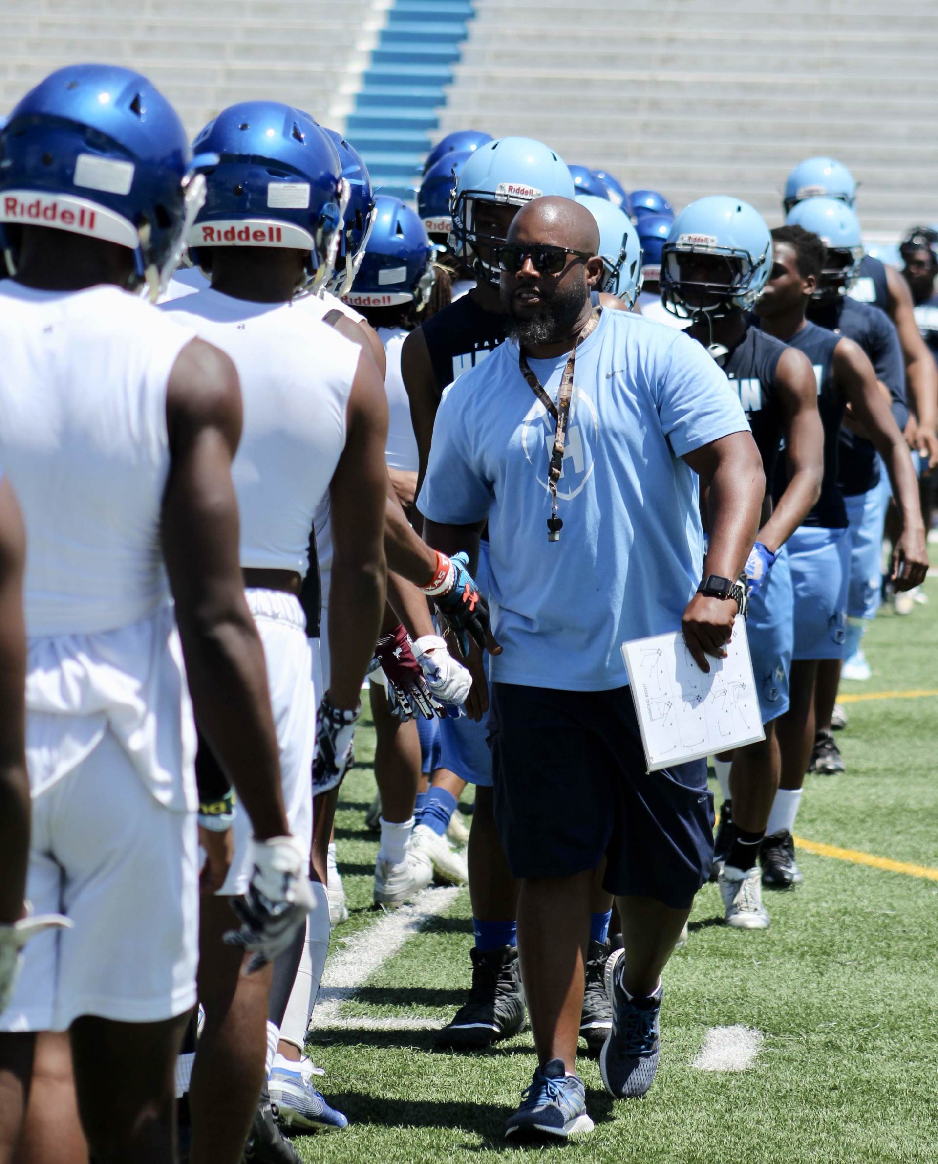 A group of football players wearing helmets that say riddell