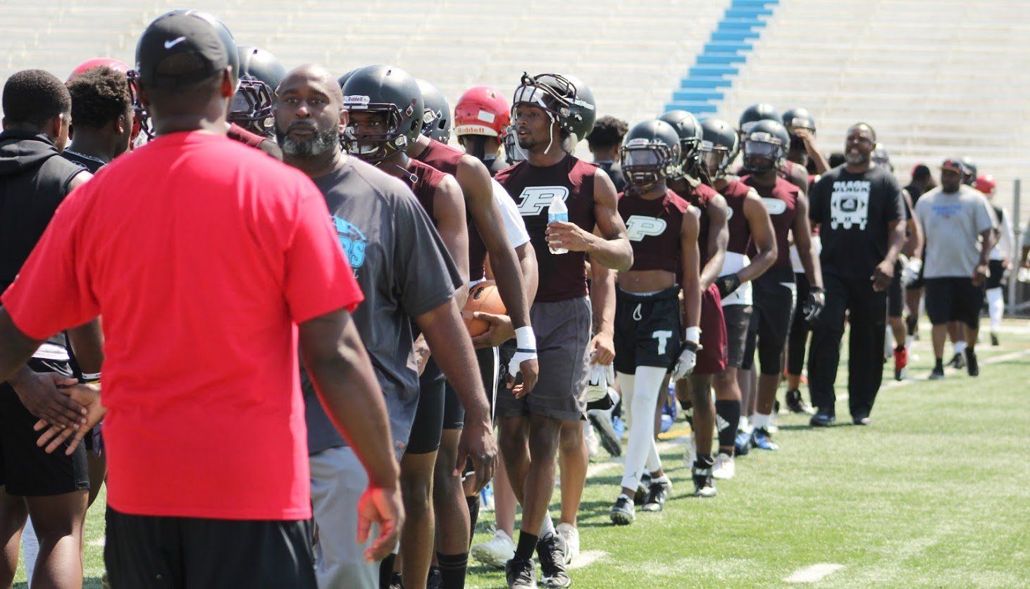A group of football players are lined up on the field