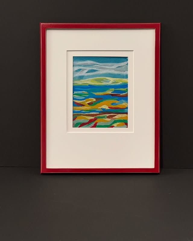 An abstract landscape painting with blue, green, and gold hues, presented in a white mat and a bright red frame.