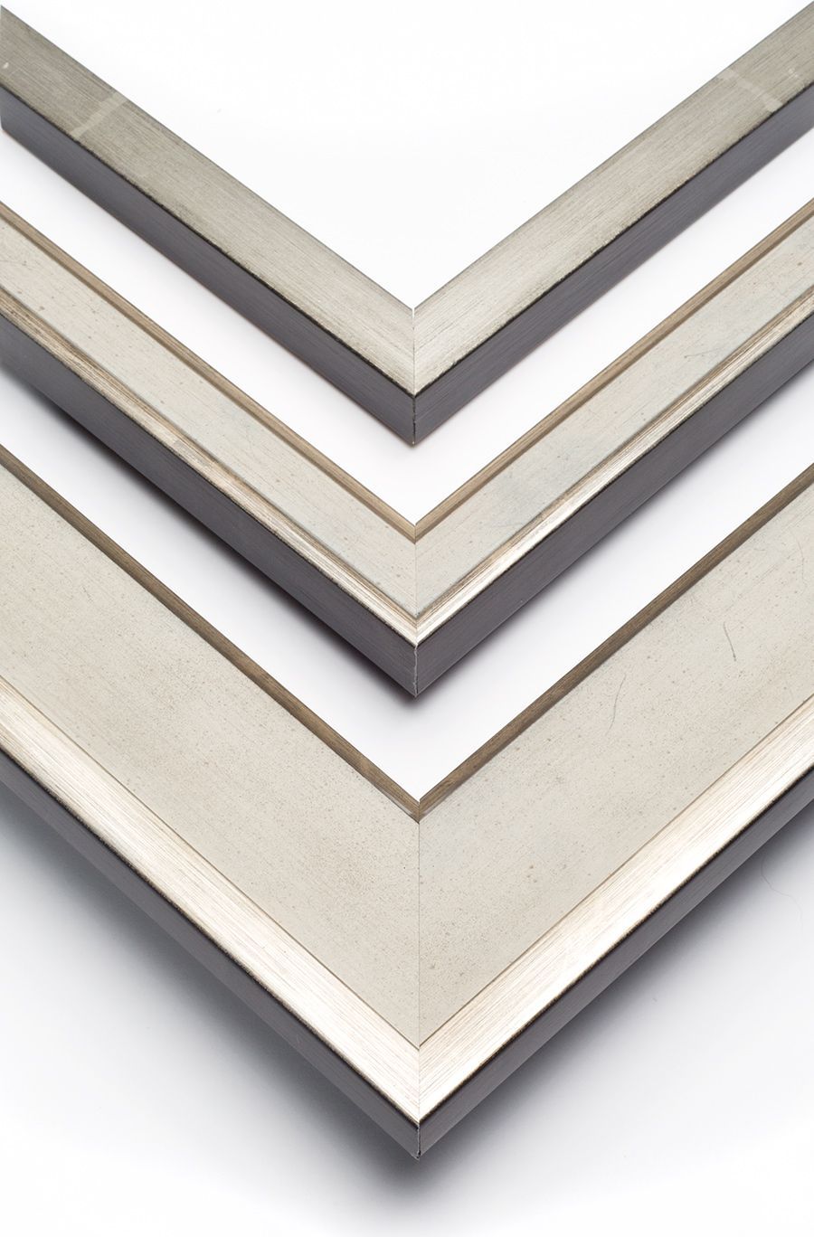 Three nested corner samples of silver-toned picture frames arranged vertically on a white background.