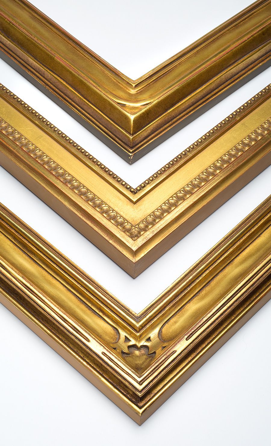 Three nested ornate gold picture frames displayed against a plain white background.