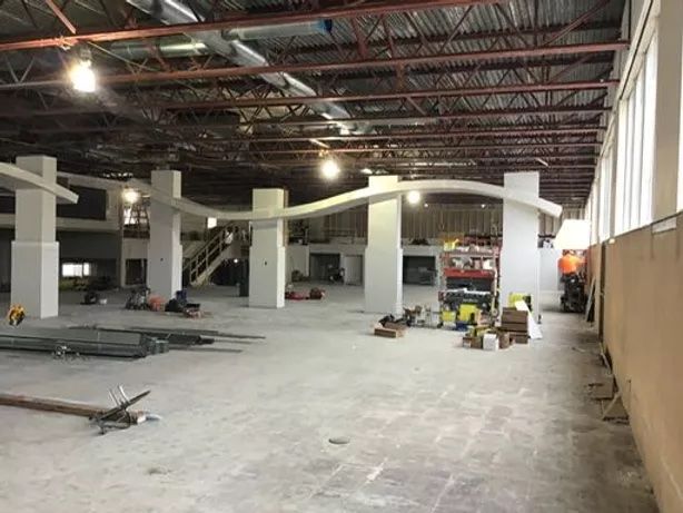 A large empty building with a lot of windows and columns.