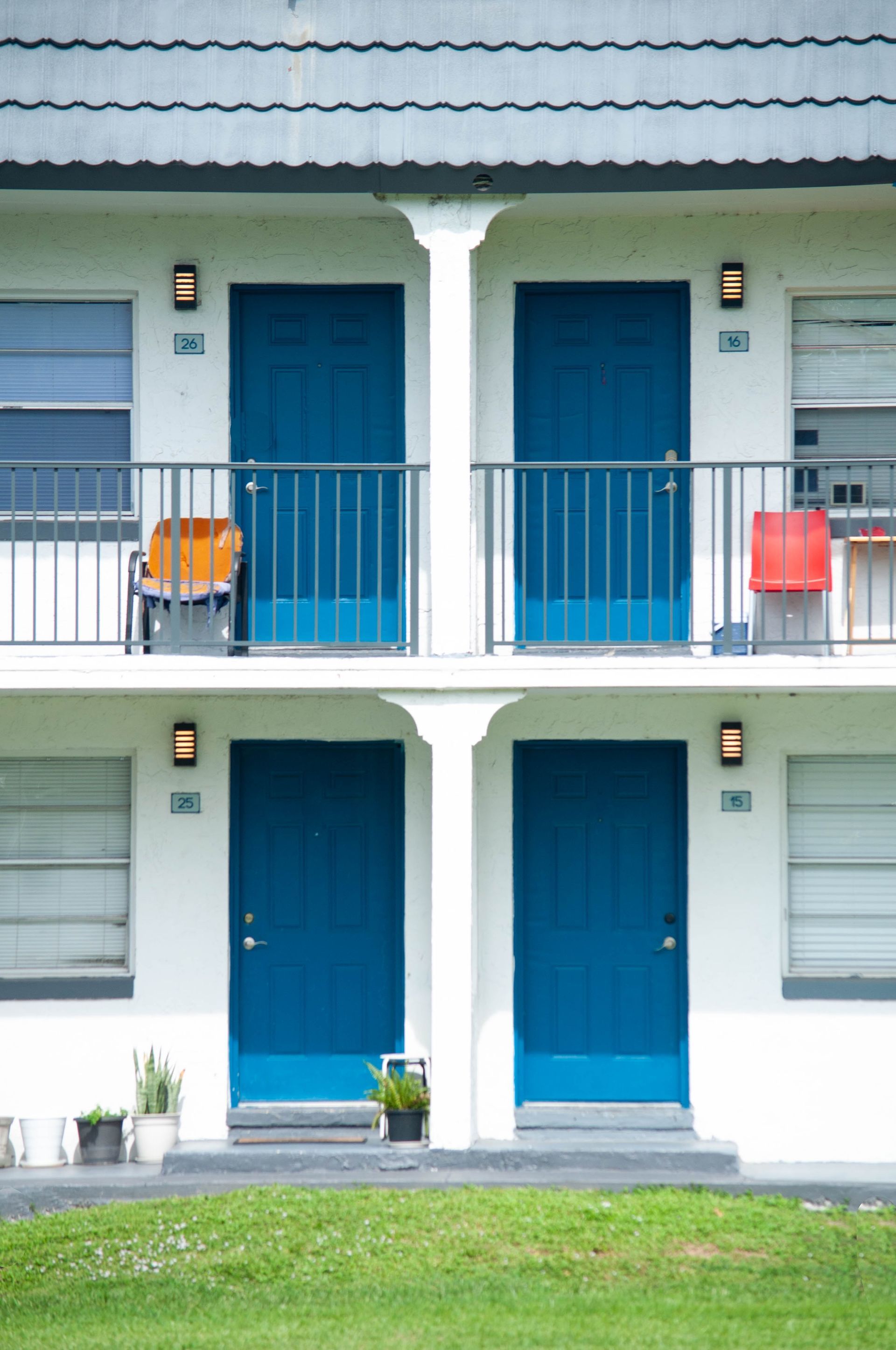 A white building with blue doors and balconies