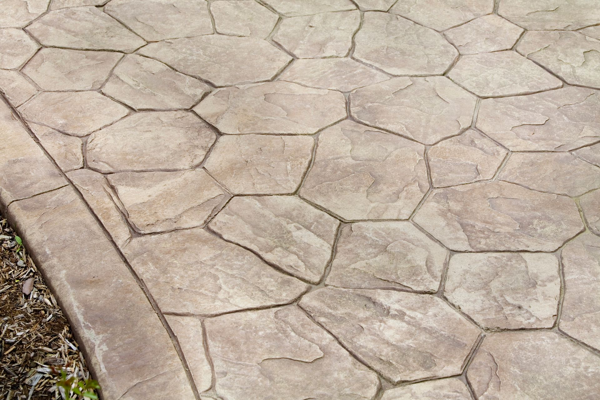 A close up of a concrete walkway with a geometric pattern