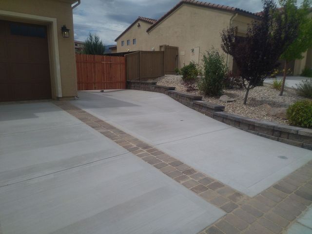 A Driveway Leading to a House with a Garage and a Wooden Fence – Reno, NV – Concreteworks LLC