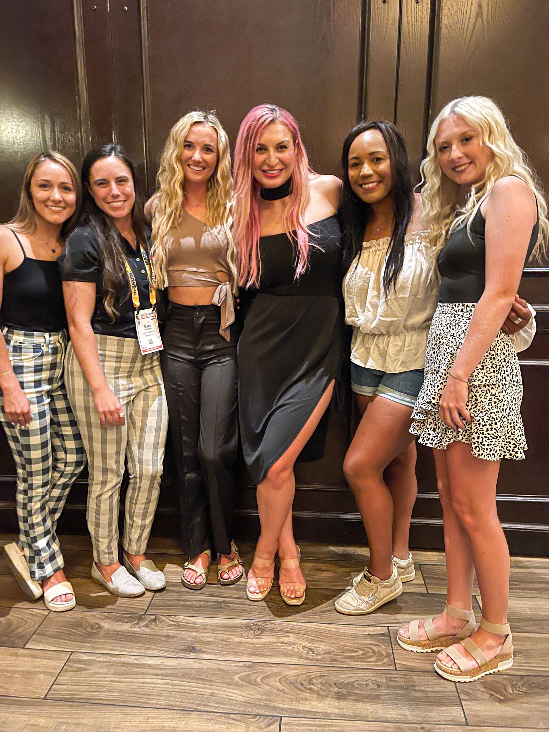 a group of women posing for a picture with one wearing a name tag that says ' amanda ' on it