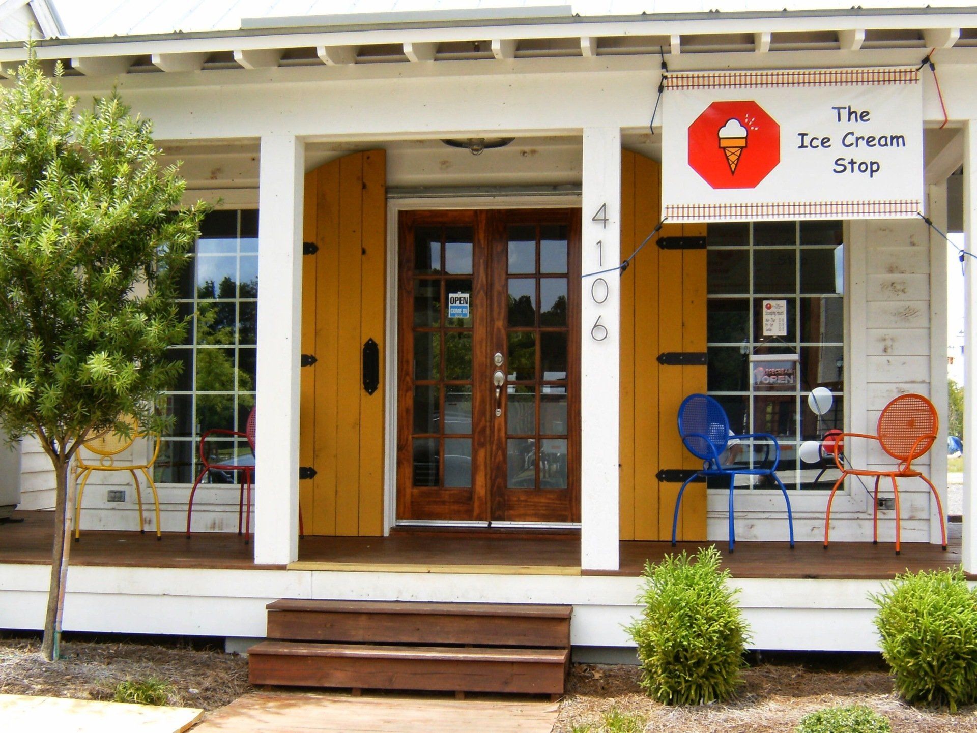 A white house with a sign that says the ice cream stop