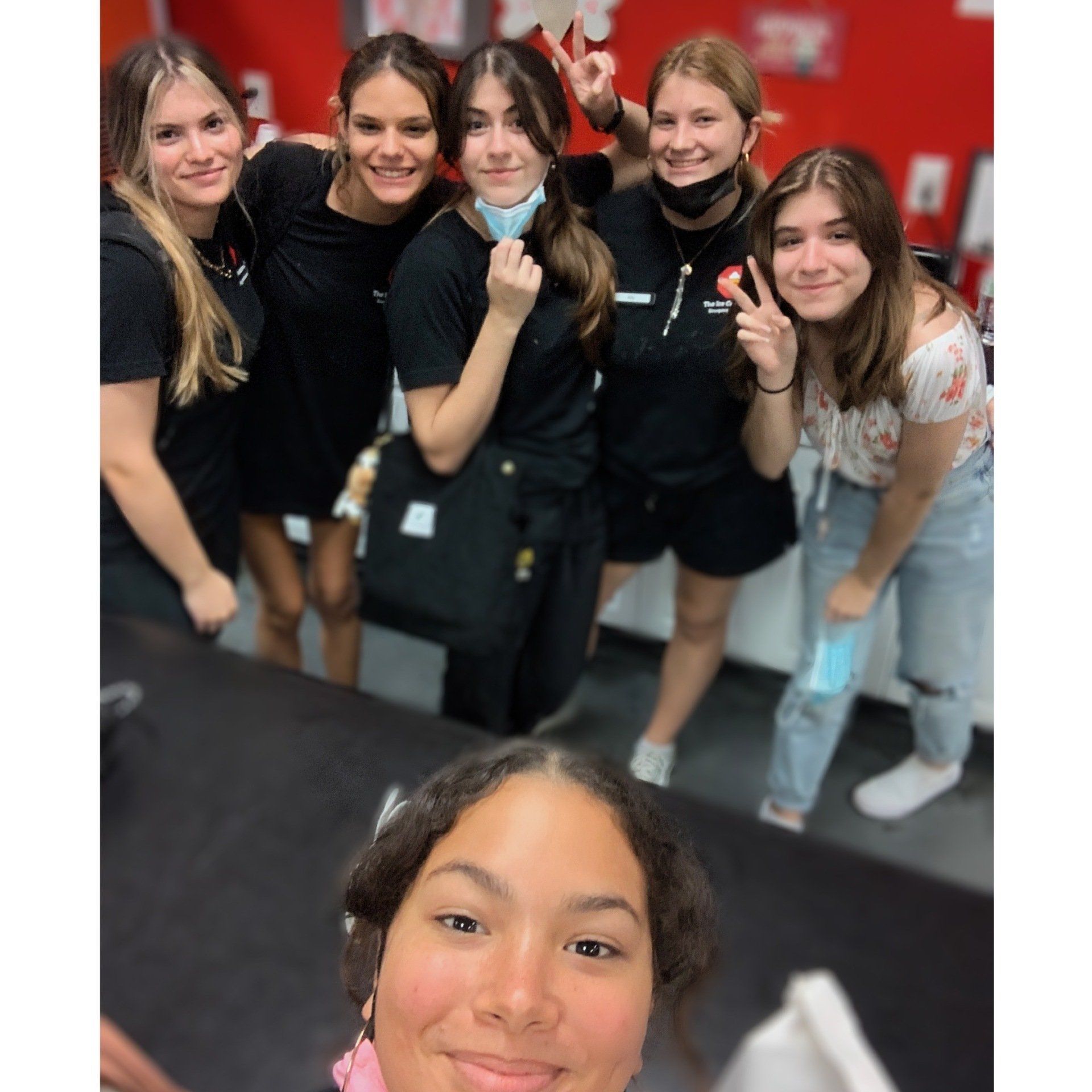 A group of young women are posing for a picture together.