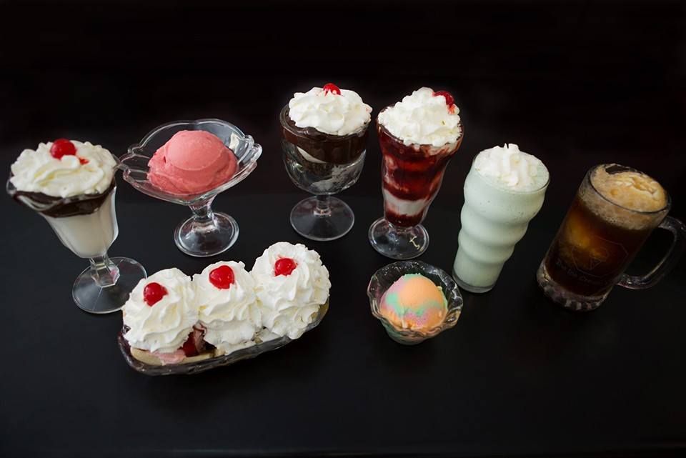 A table topped with a variety of desserts and drinks.