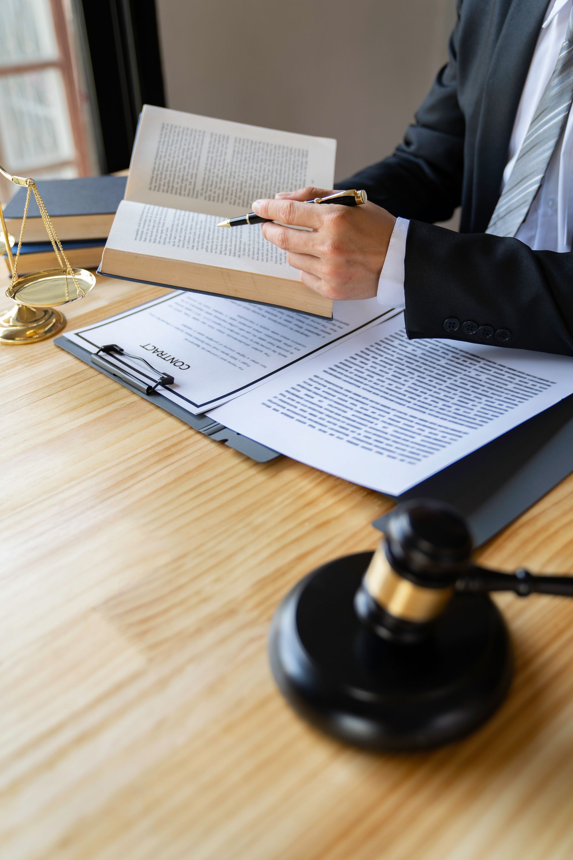 Attorney reading law code, studying constitution to protect human rights closeup, Male lawyer or judge working with Law books, gavel.