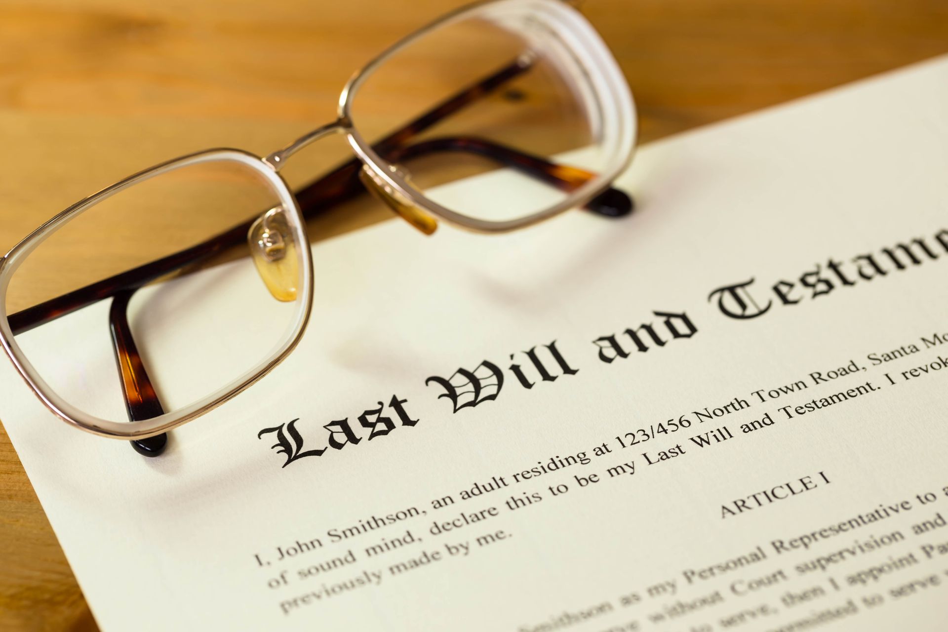 Last will and testament on cream color paper with glasses.
