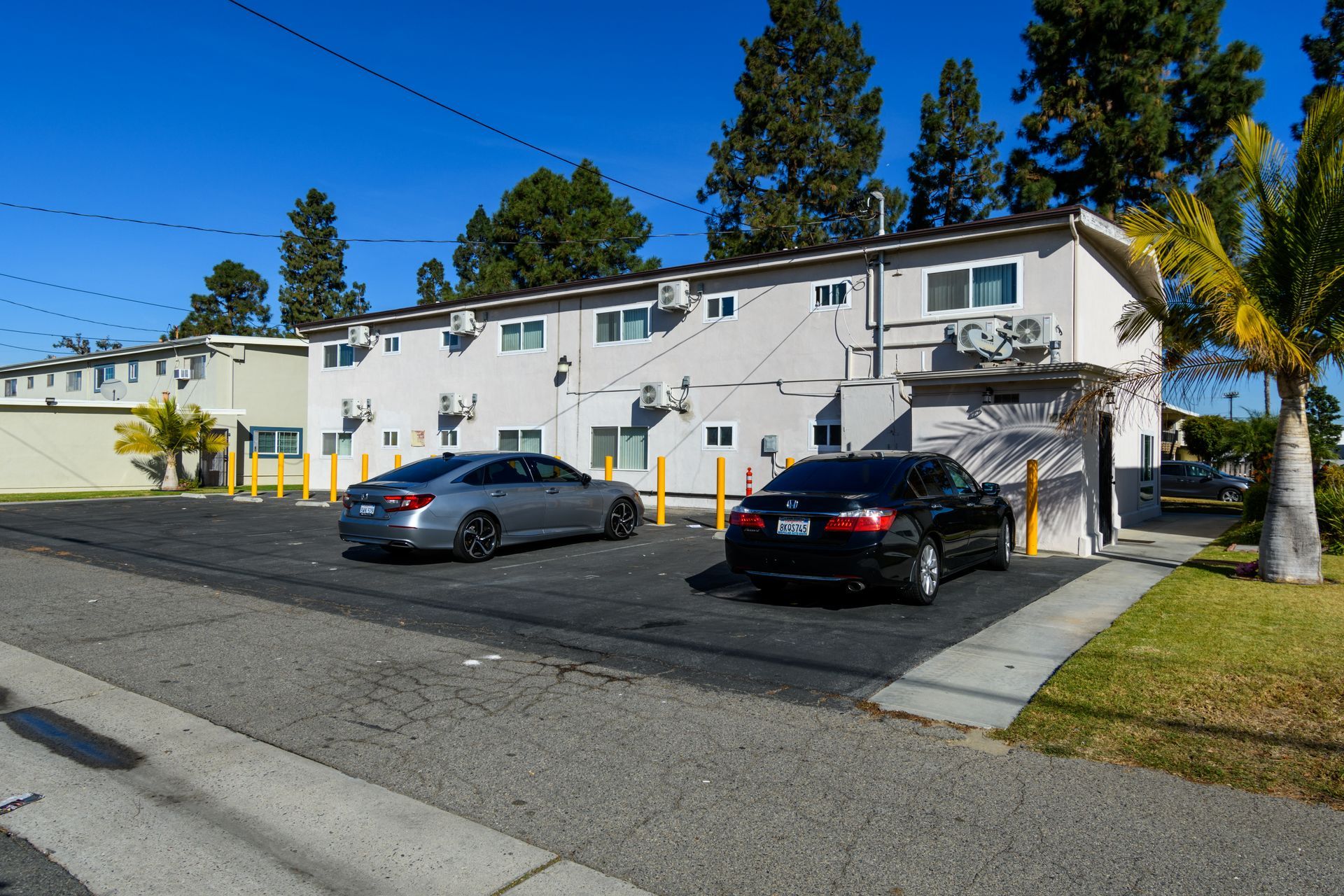 A couple of cars are parked in front of a building