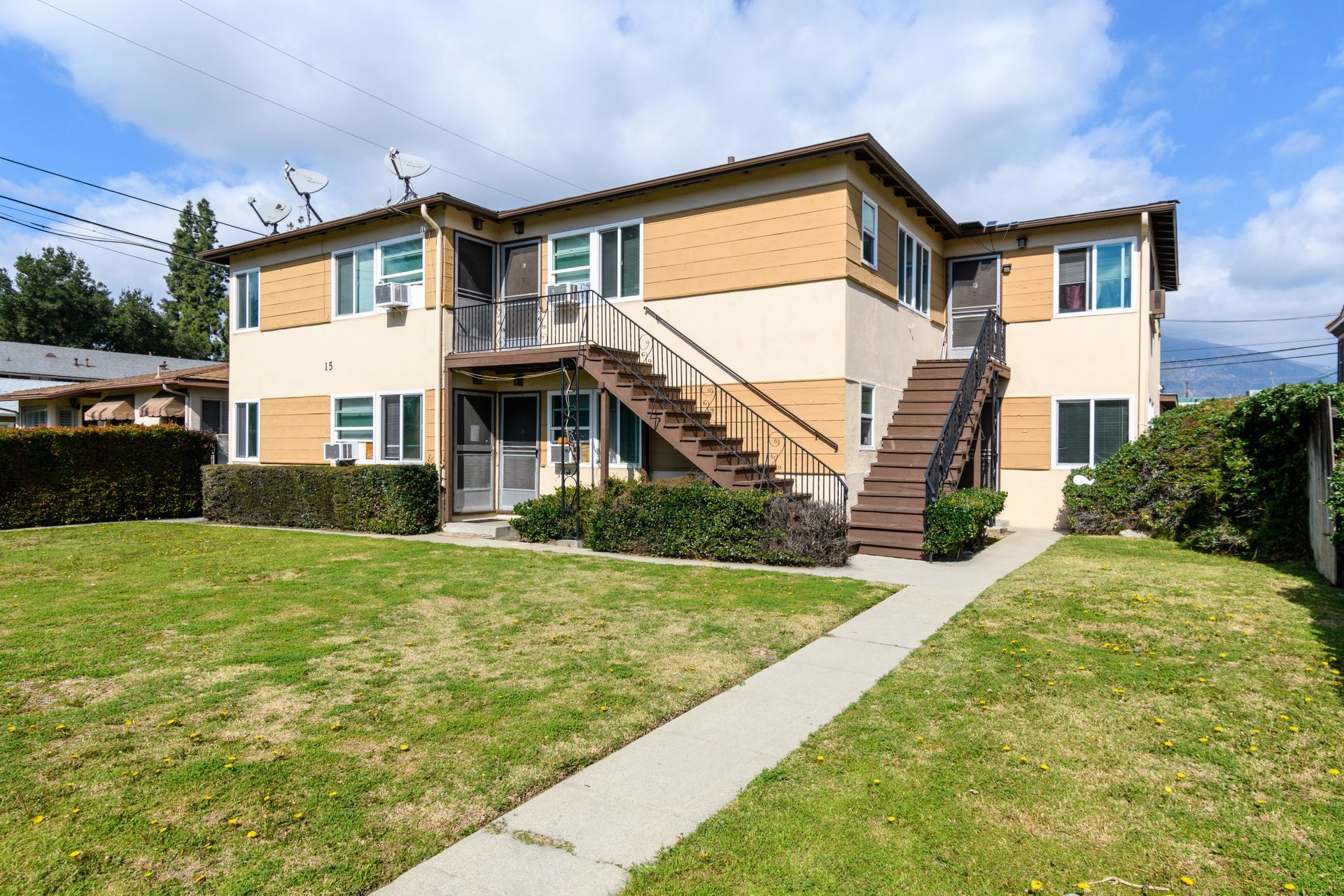 A large apartment building with stairs leading up to the second floor