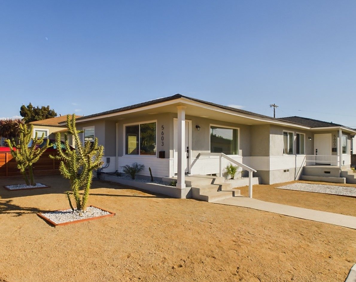 A small house with a cactus in front of it