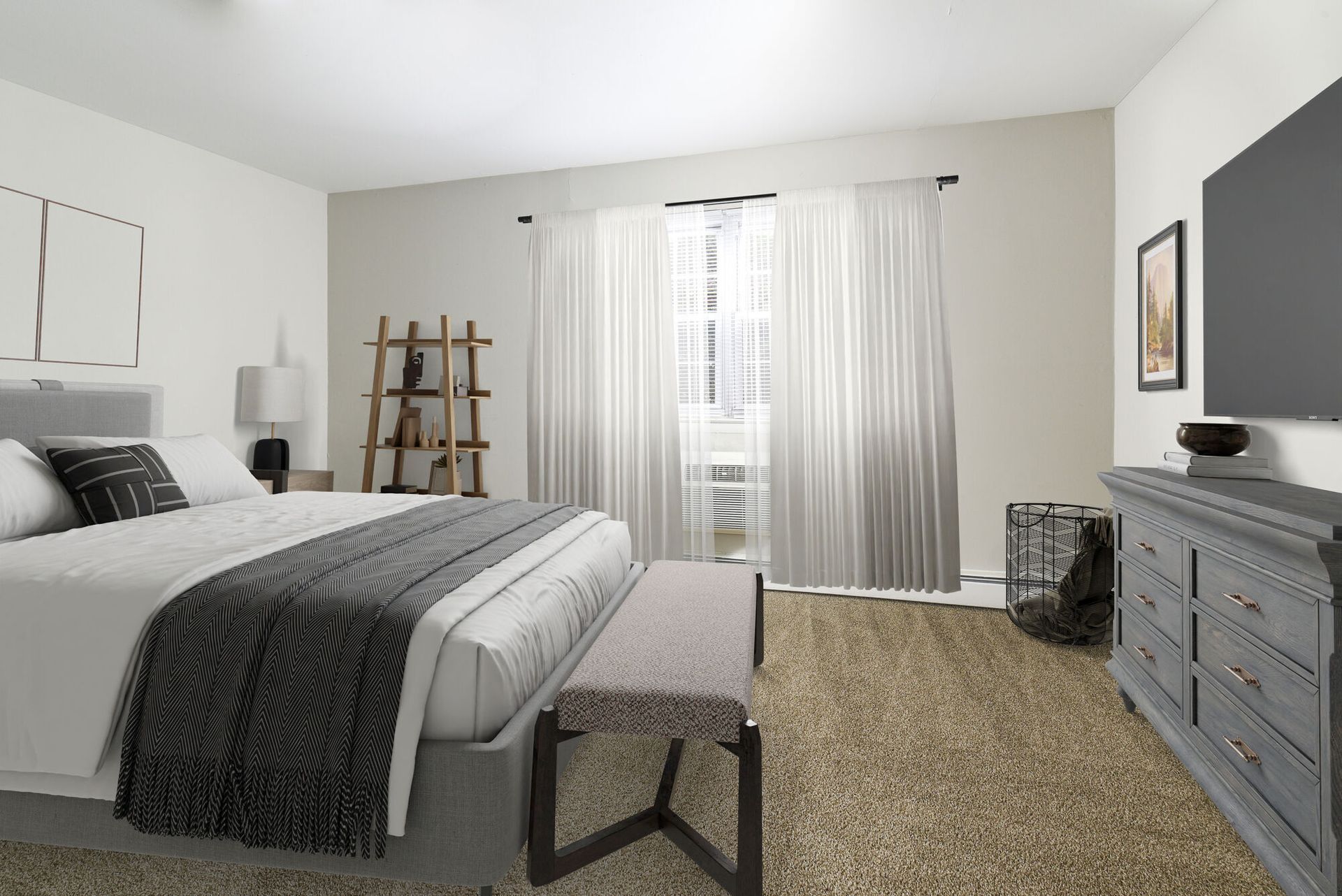 Bedroom in an apartment with a large bed, bench at foot, dresser, and window with white curtains.