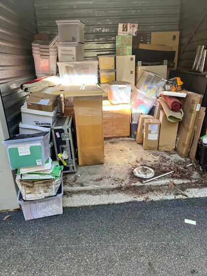 A storage shed filled with lots of boxes and boxes.