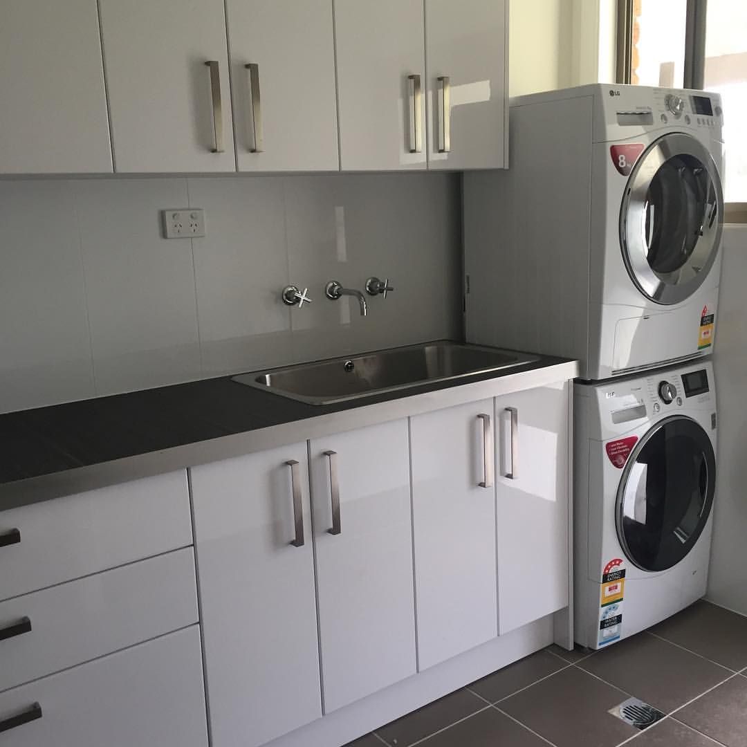 A Kitchen With a Washer and Dryer Stacked on Top of Each Other — All Plumb & Gas in North Boambee Valley, NSW