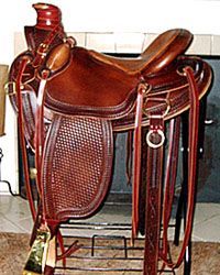 Brown leather western saddle on a stand; detailed with basketweave, stirrups, and a high cantle.