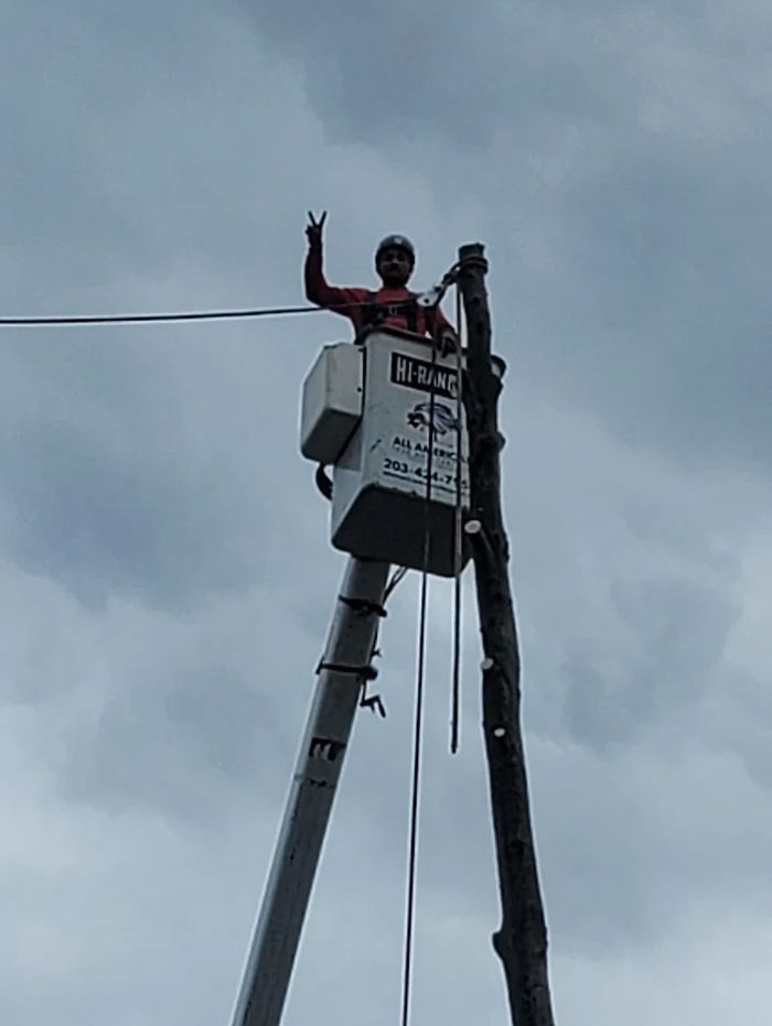 Lineman in bucket truck, giving a 