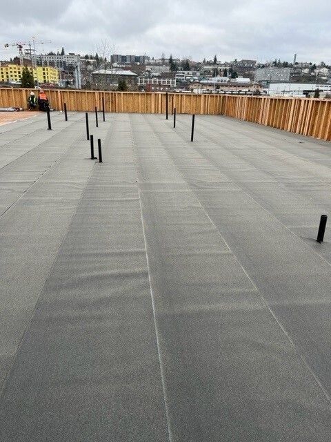 A large concrete surface with a wooden fence in the background