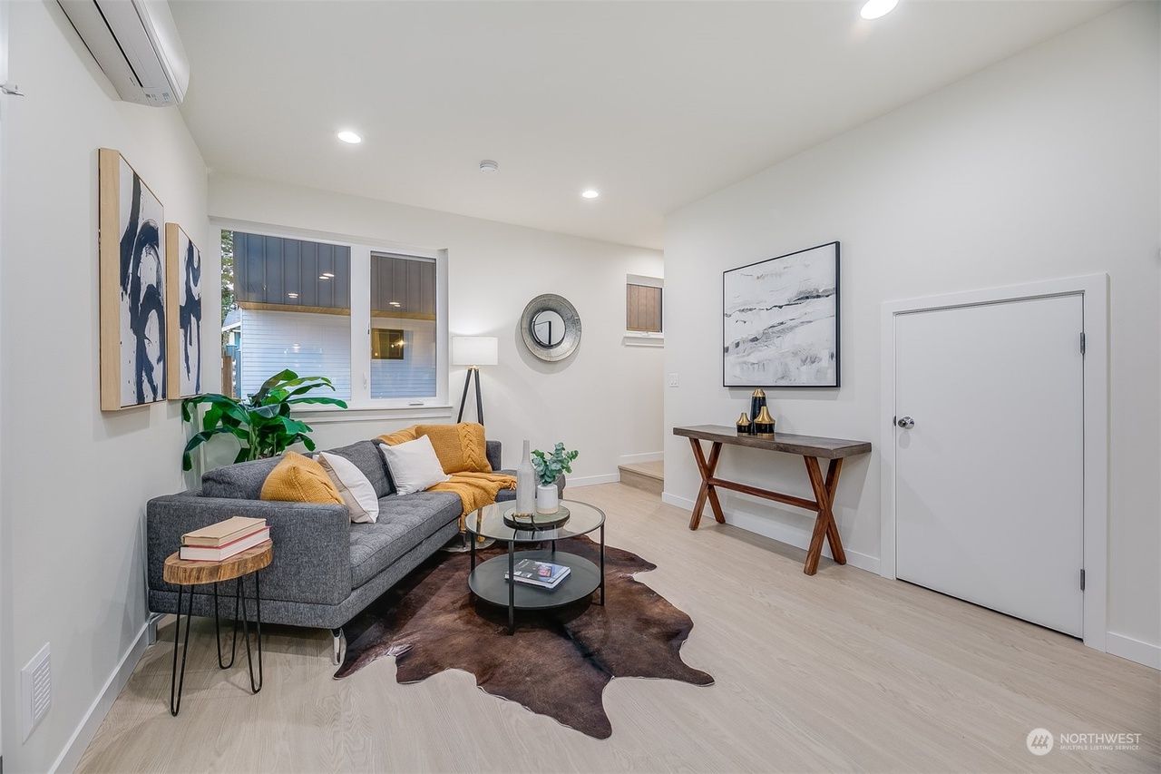 A living room with a couch , coffee table , and rug.