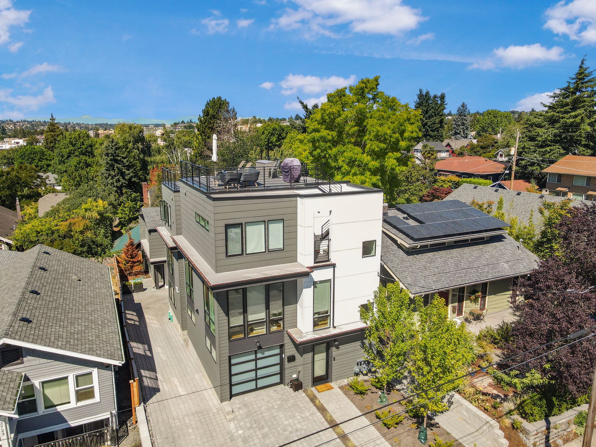An aerial view of a house with solar panels on the roof