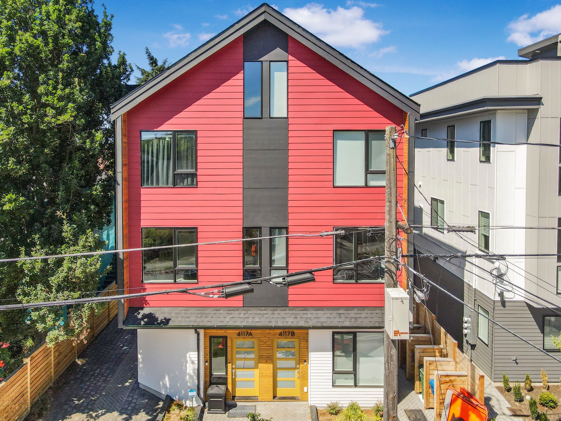 A red and black house with a lot of windows