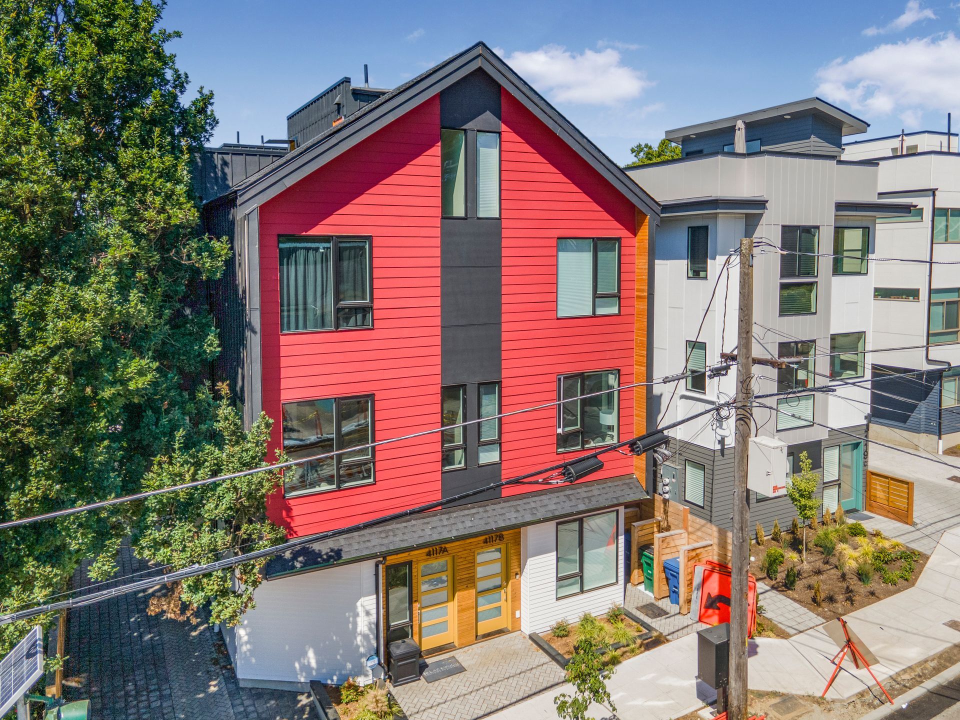 An aerial view of a red building with a black roof