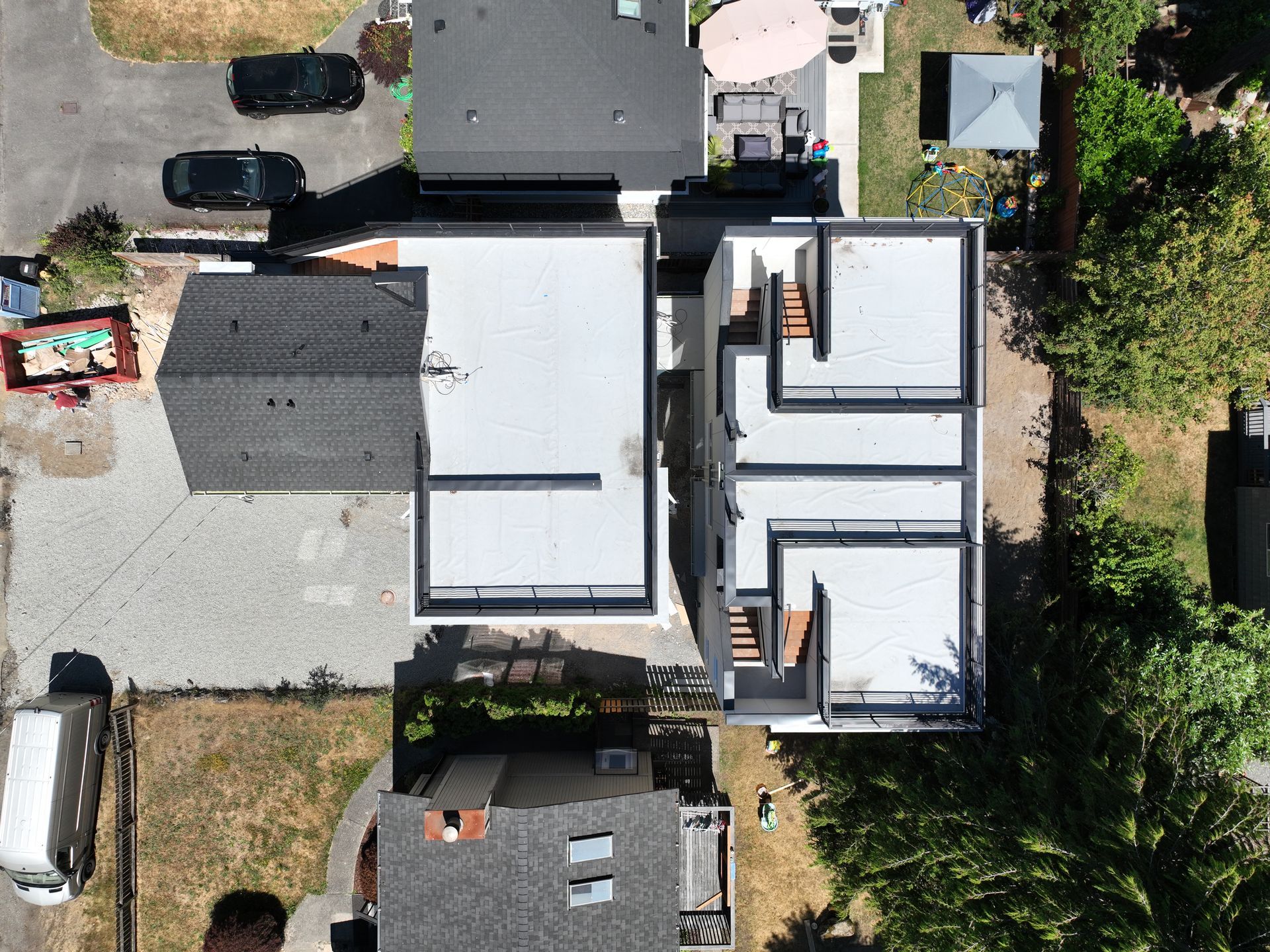 An aerial view of a house with a white roof