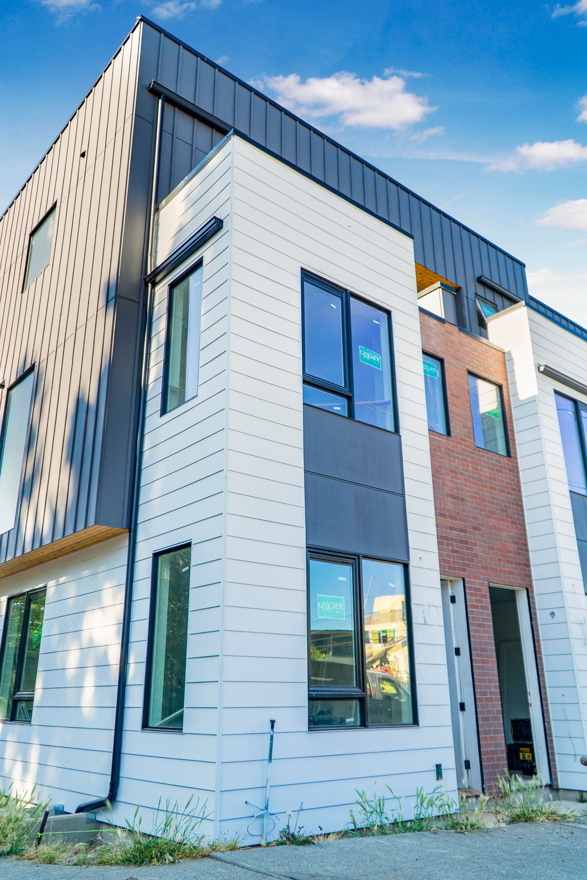 A large white building with a lot of windows and a blue sky in the background.