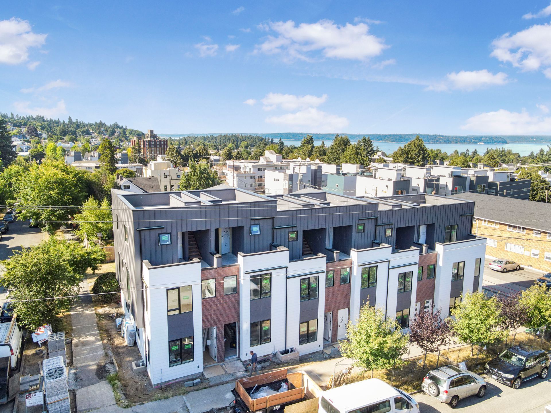 An aerial view of a building under construction in a city.