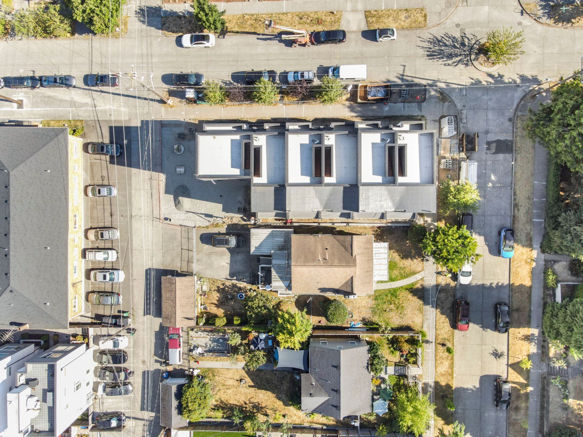 An aerial view of a residential area with houses and cars