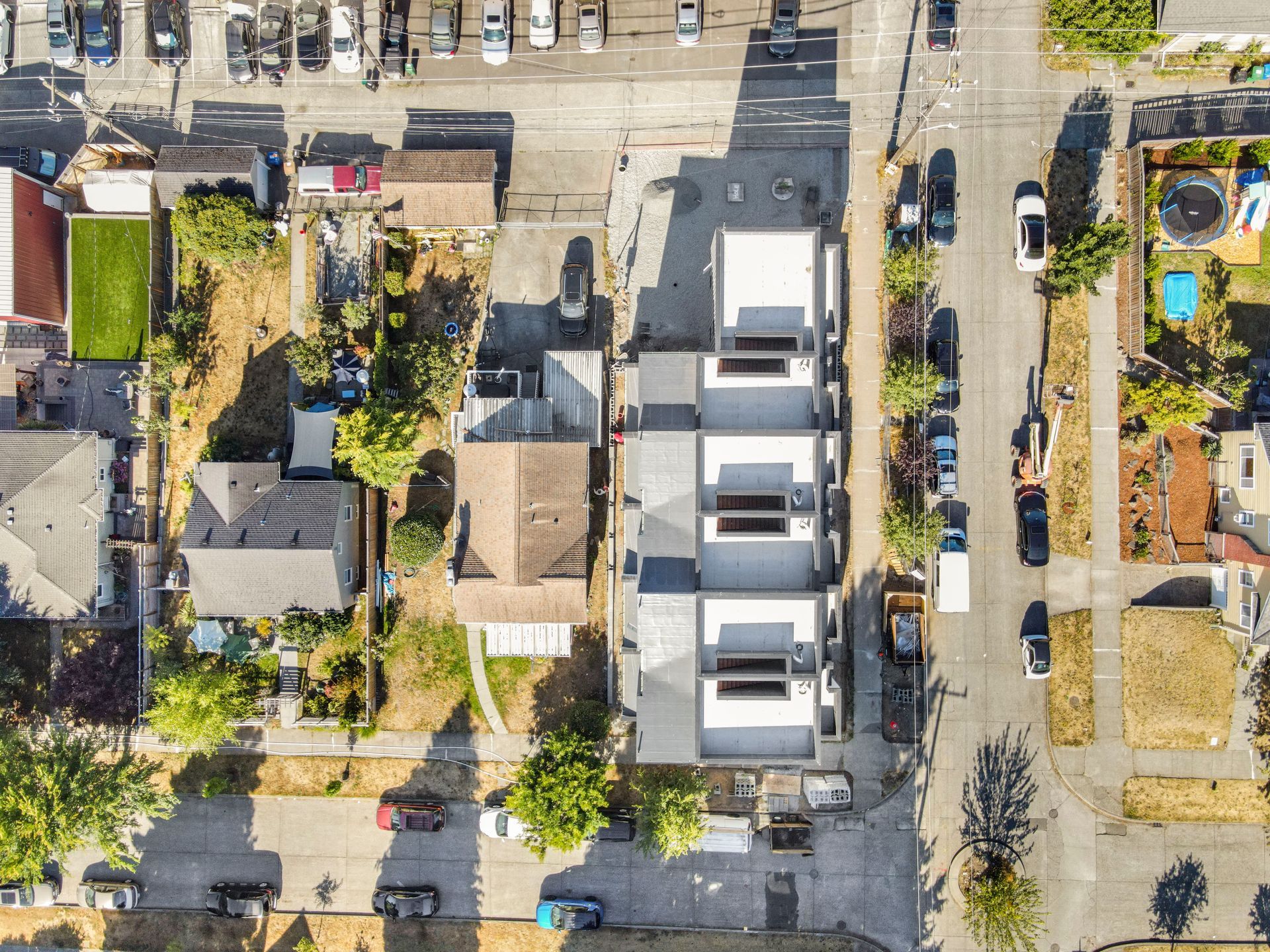 An aerial view of a residential area with lots of houses and cars.