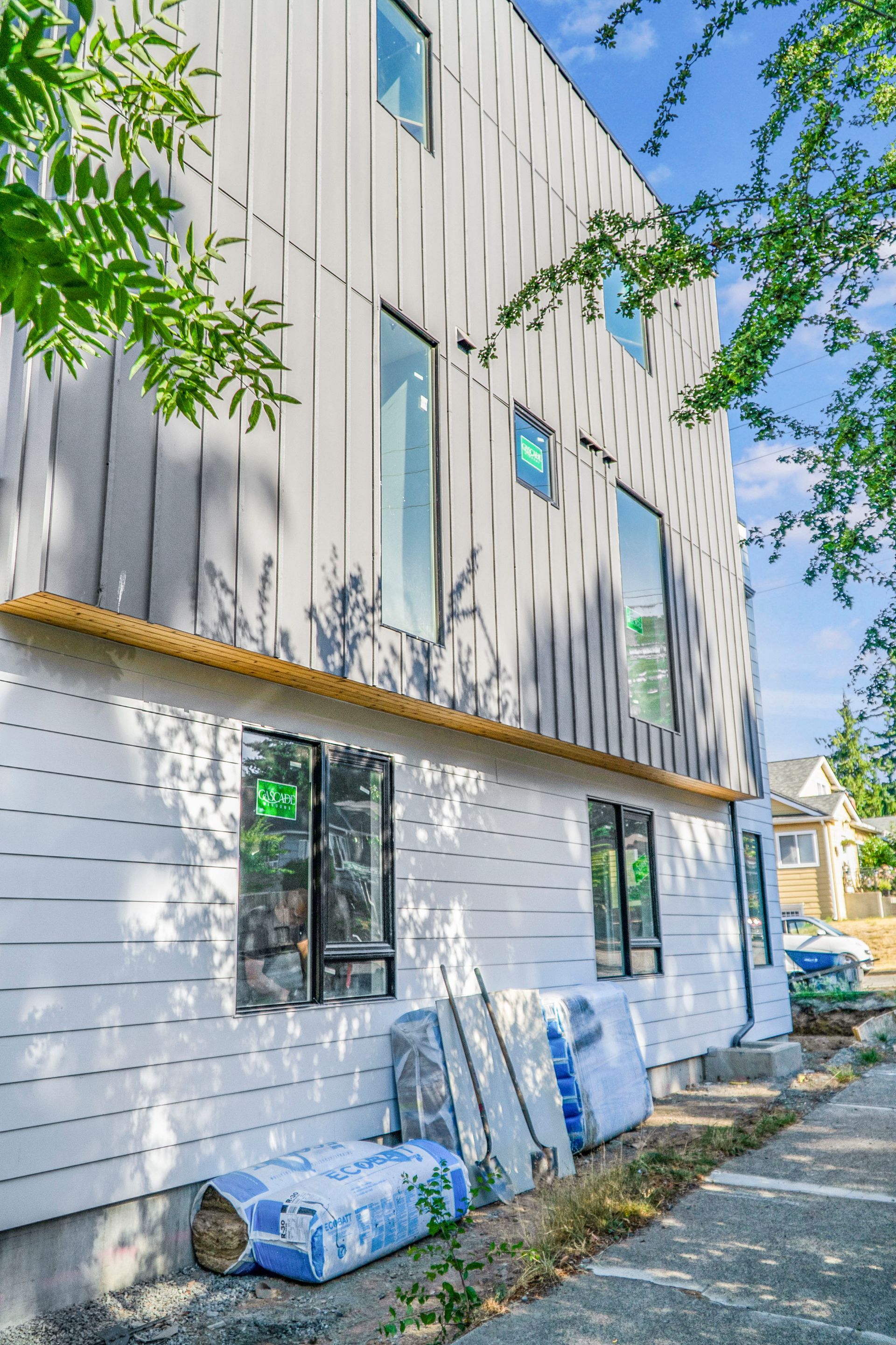 The side of a building under construction with a lot of windows.