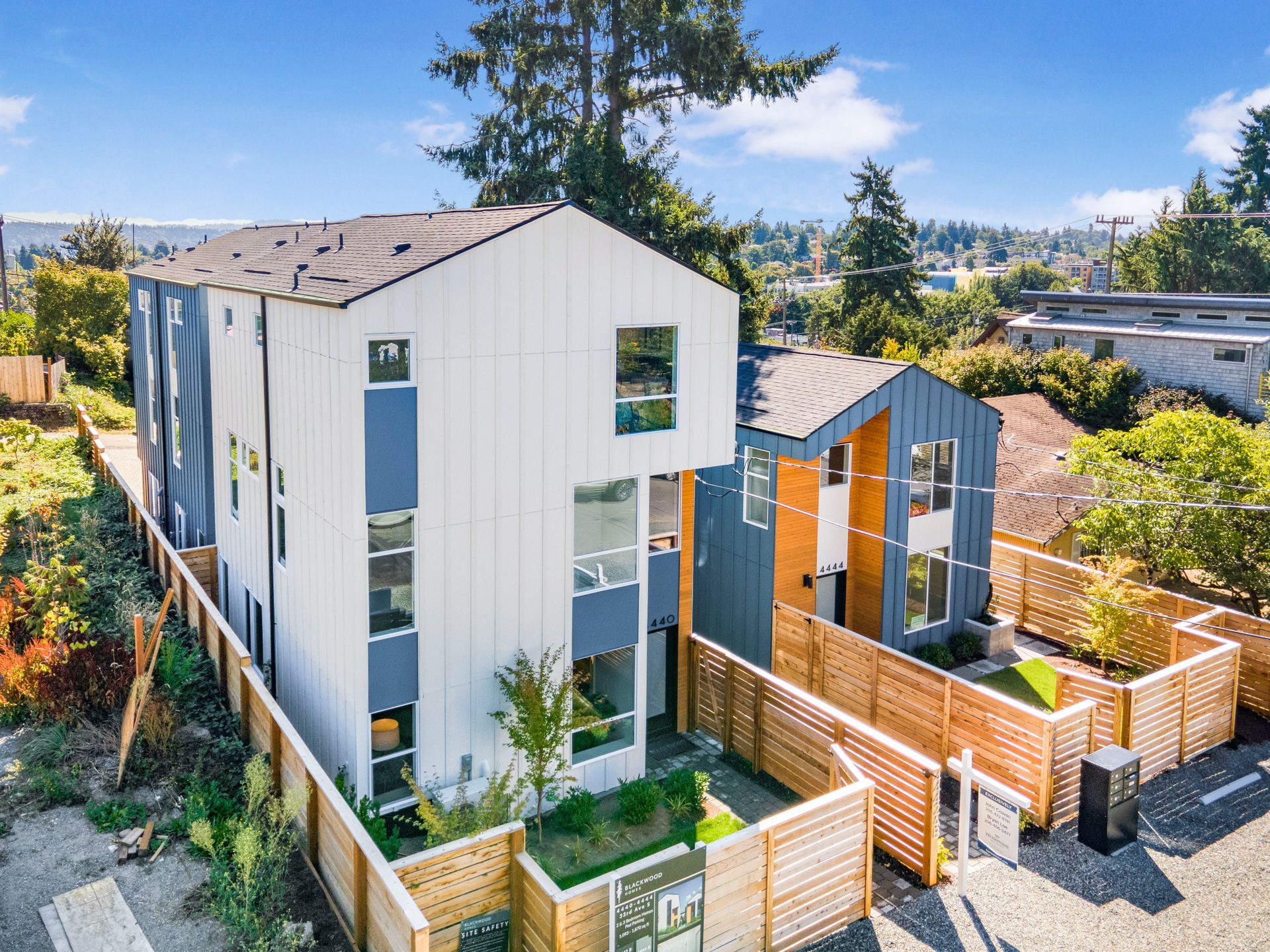 An aerial view of a house with a wooden fence around it.