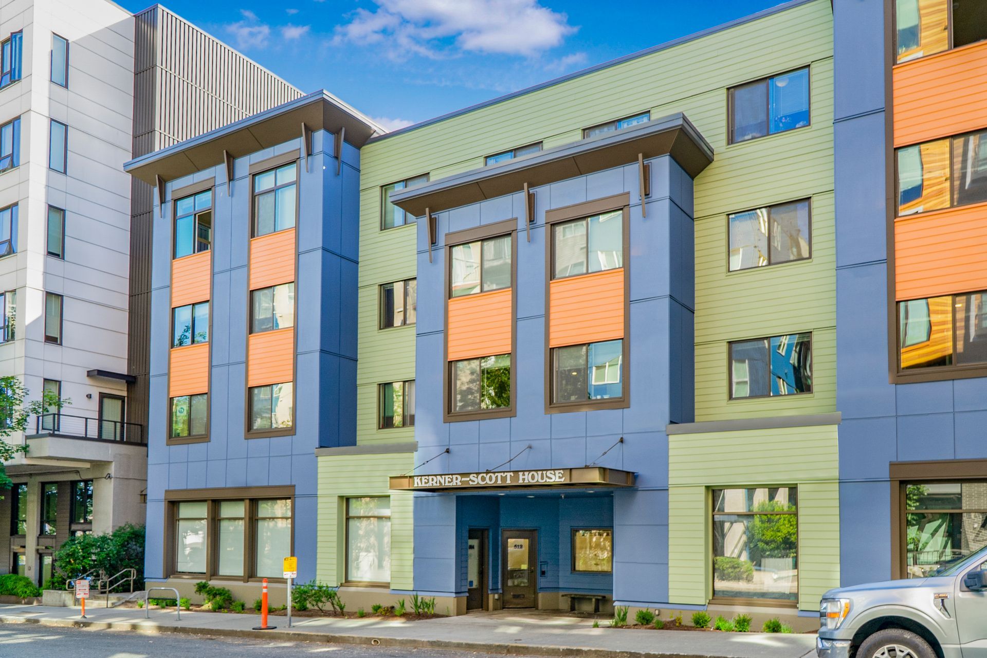 A large building with a lot of windows and a car parked in front of it.