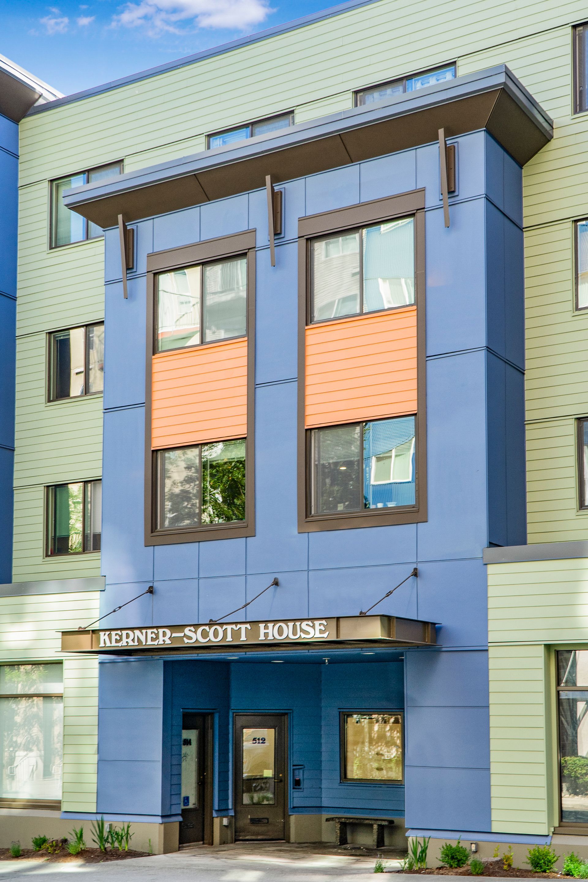 A blue building with a sign that says ' scott house ' on it