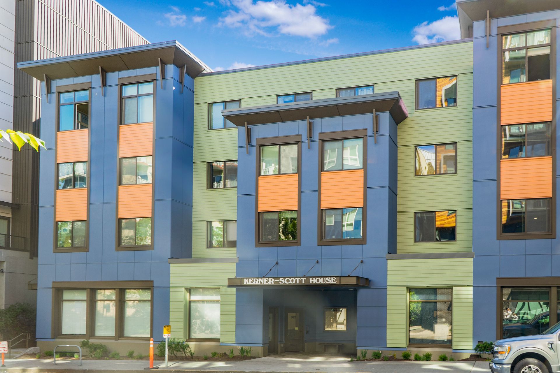 A large building with a lot of windows and a car parked in front of it.