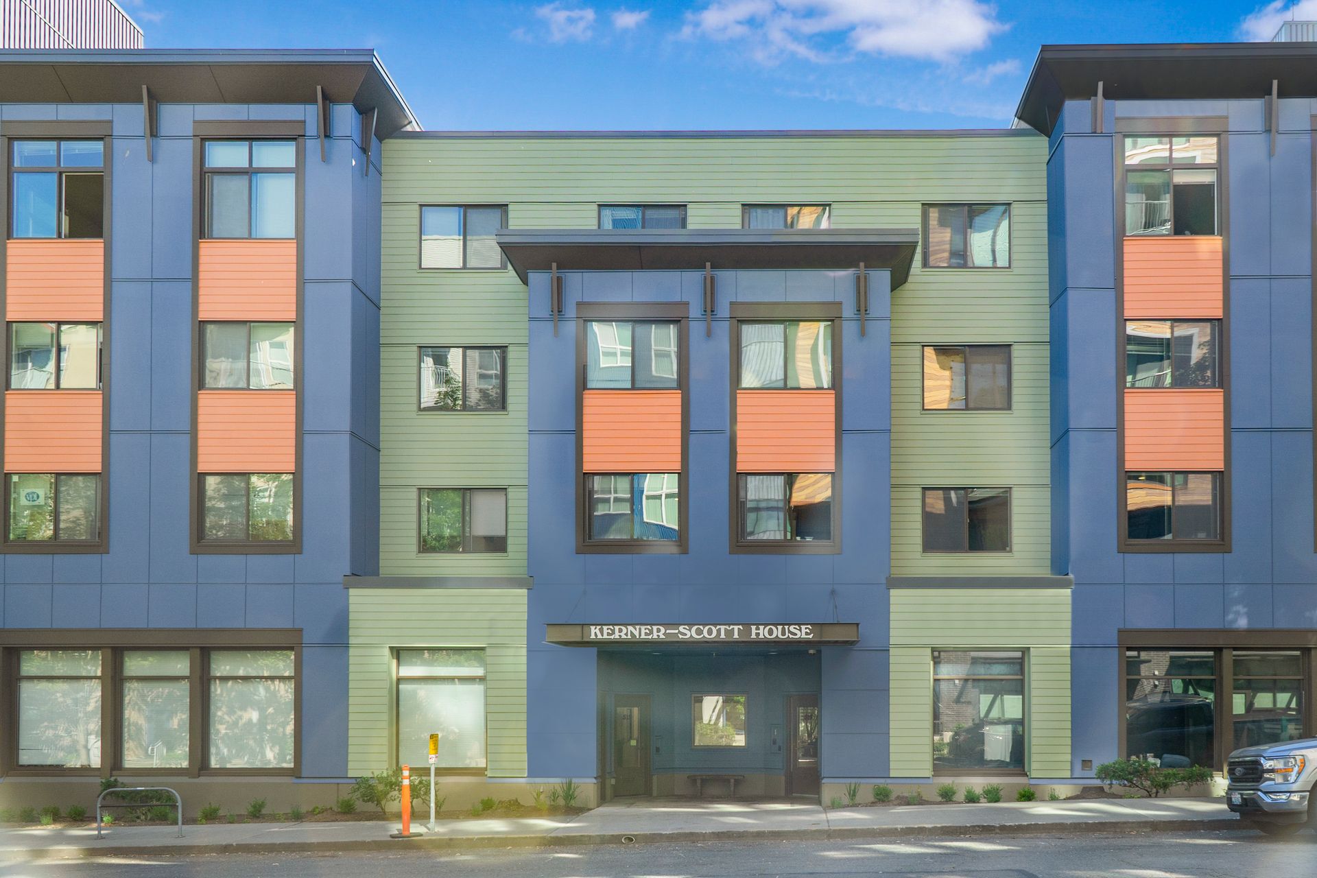 A large building with a lot of windows and a car parked in front of it.