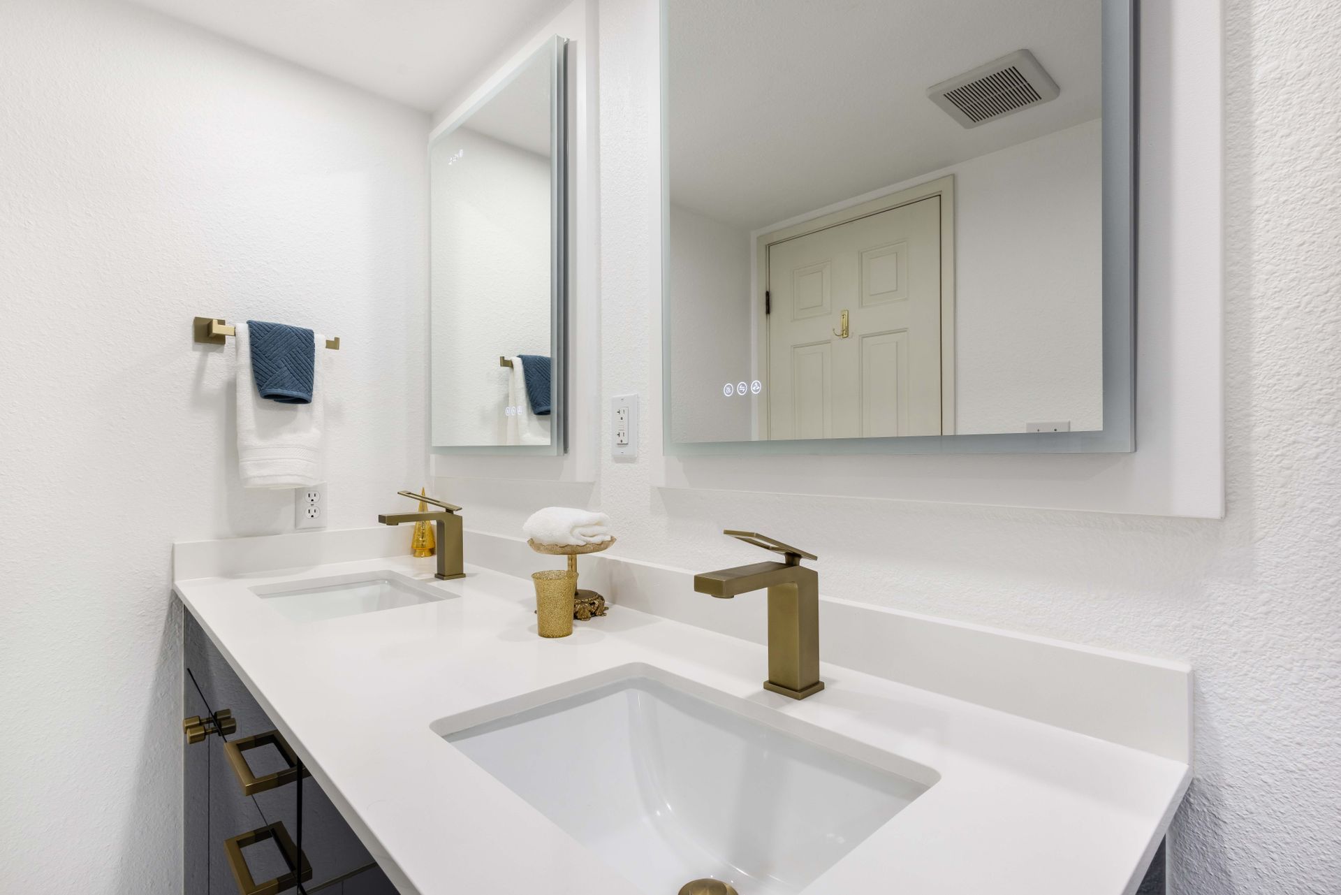 A bathroom with two sinks and two mirrors.