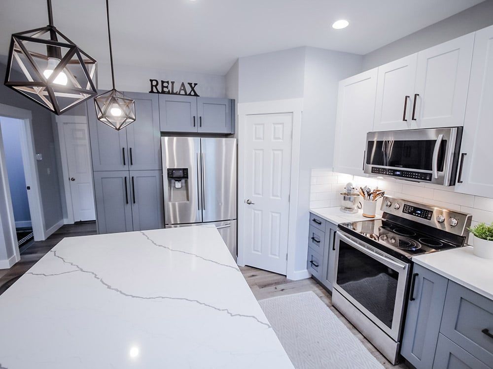 A kitchen with stainless steel appliances and a sign that says relax.