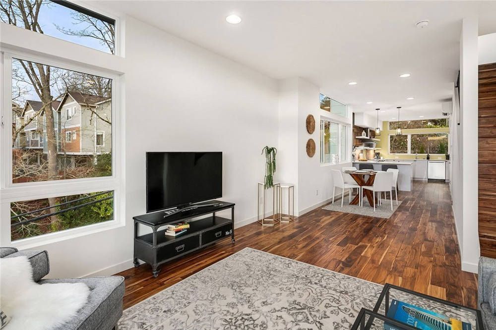 A living room with hardwood floors and a flat screen tv.