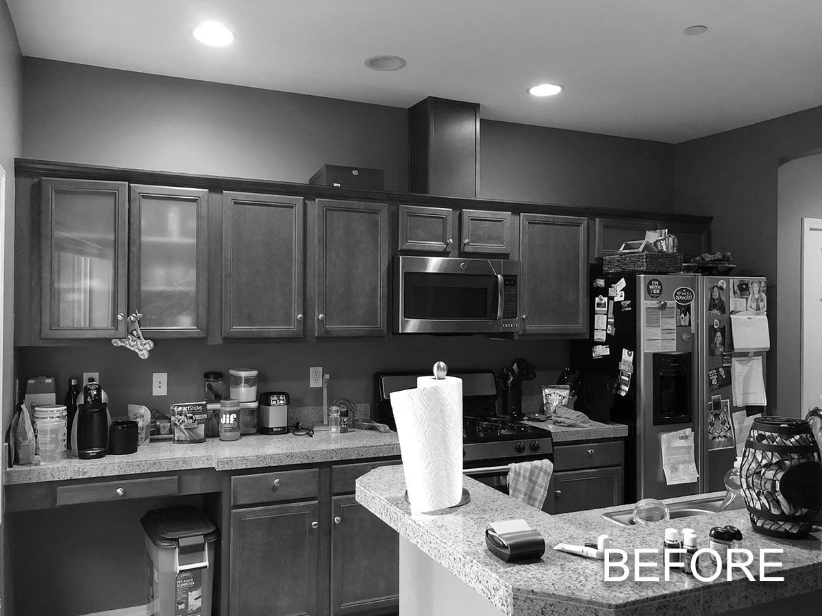 A black and white photo of a kitchen before being remodeled