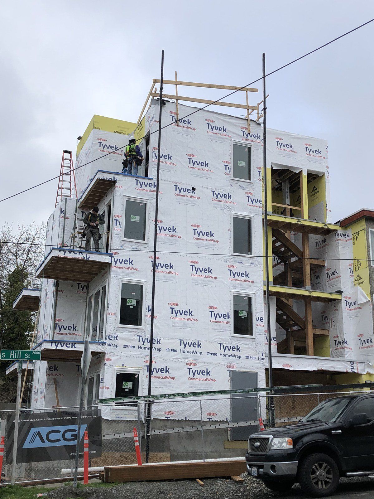 A building under construction with a truck parked in front of it.