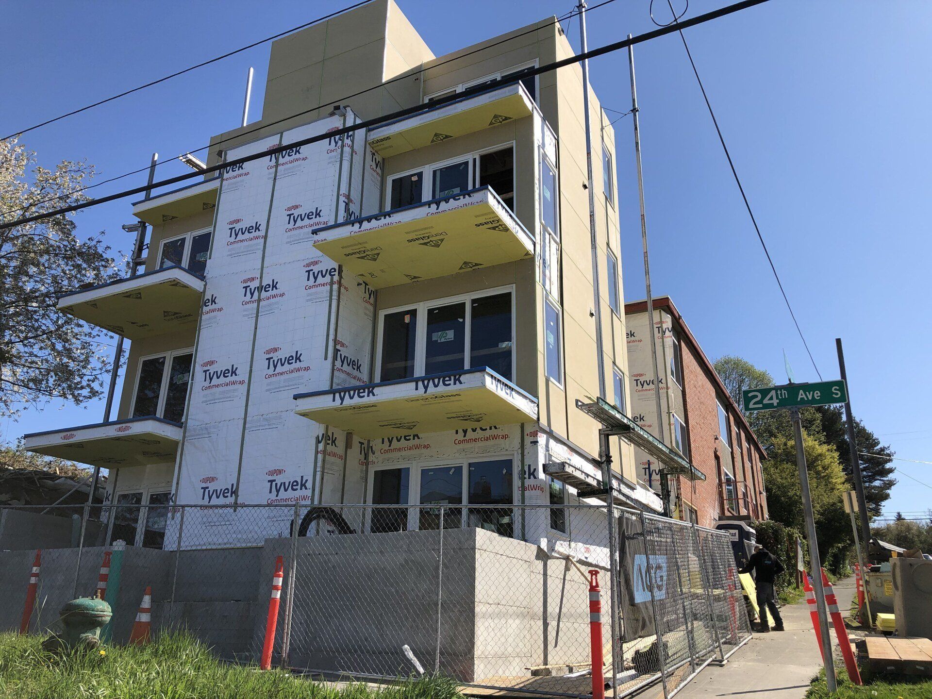 A building under construction with a fence around it.